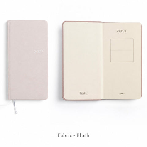 CRENA 2027 weekly planner with blush fabric cover, showing the front cover and inside title page