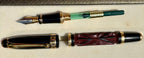 Hero Yundiao fountain pen disassembled to show the nib section, green converter, carved barrel, and cap