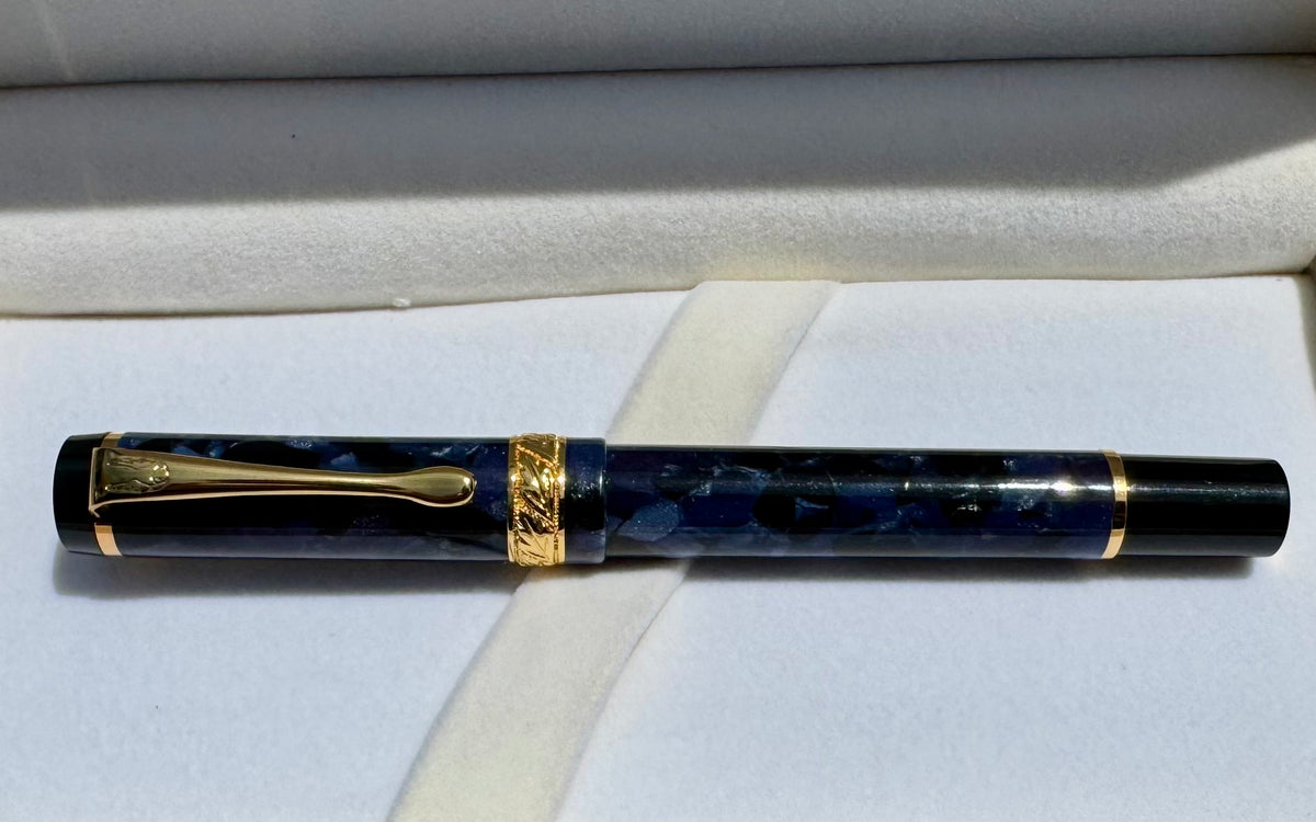 Capped Hero 2006 fountain pen in blue cracked ice acrylic with gold-tone trim in its presentation box