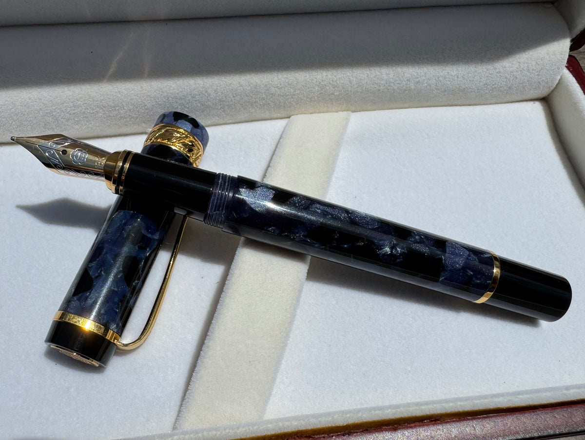 Uncapped Hero 2006 blue cracked ice fountain pen with its 18K gold nib and cap in the presentation box
