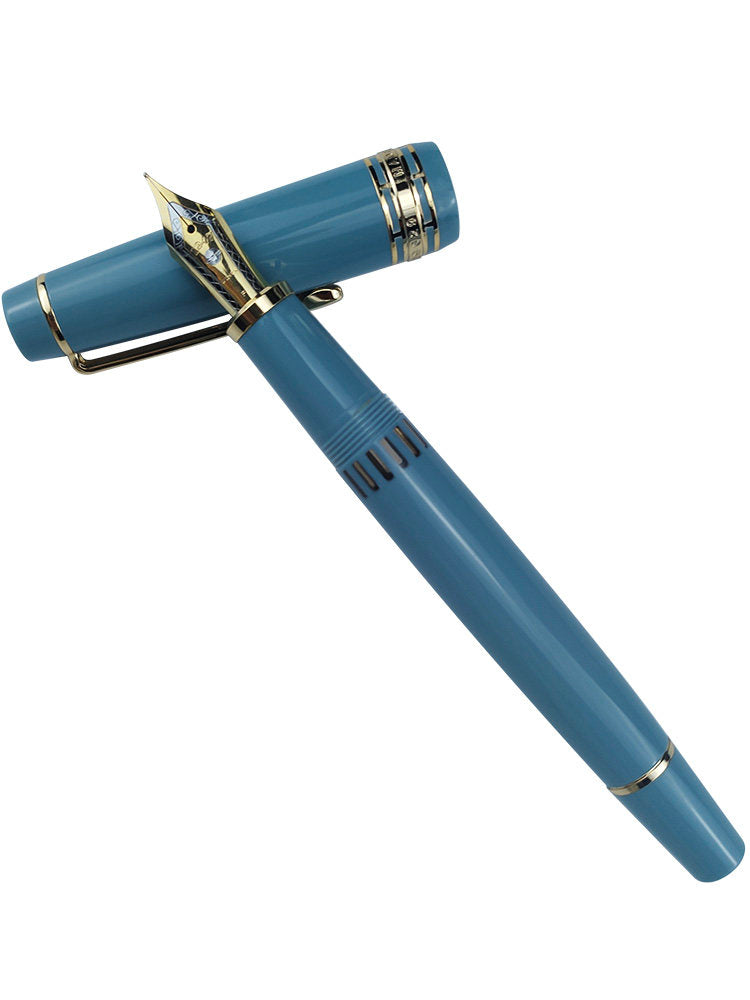 Uncapped lake-blue Wing Sung 629 fountain pen with gold-tone trim and striped ink window