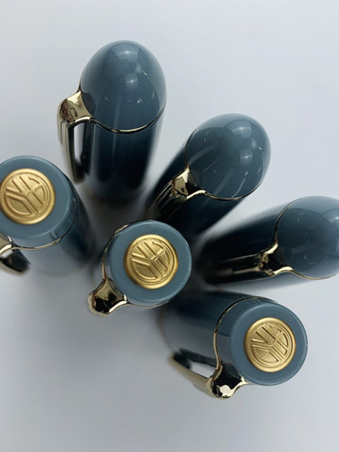 Lake-blue Wing Sung 629 fountain pen caps showing rounded tops and gold-tone finial emblems