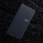 Black CRENA 2027 weekly planner with a textured cover and silver year lettering