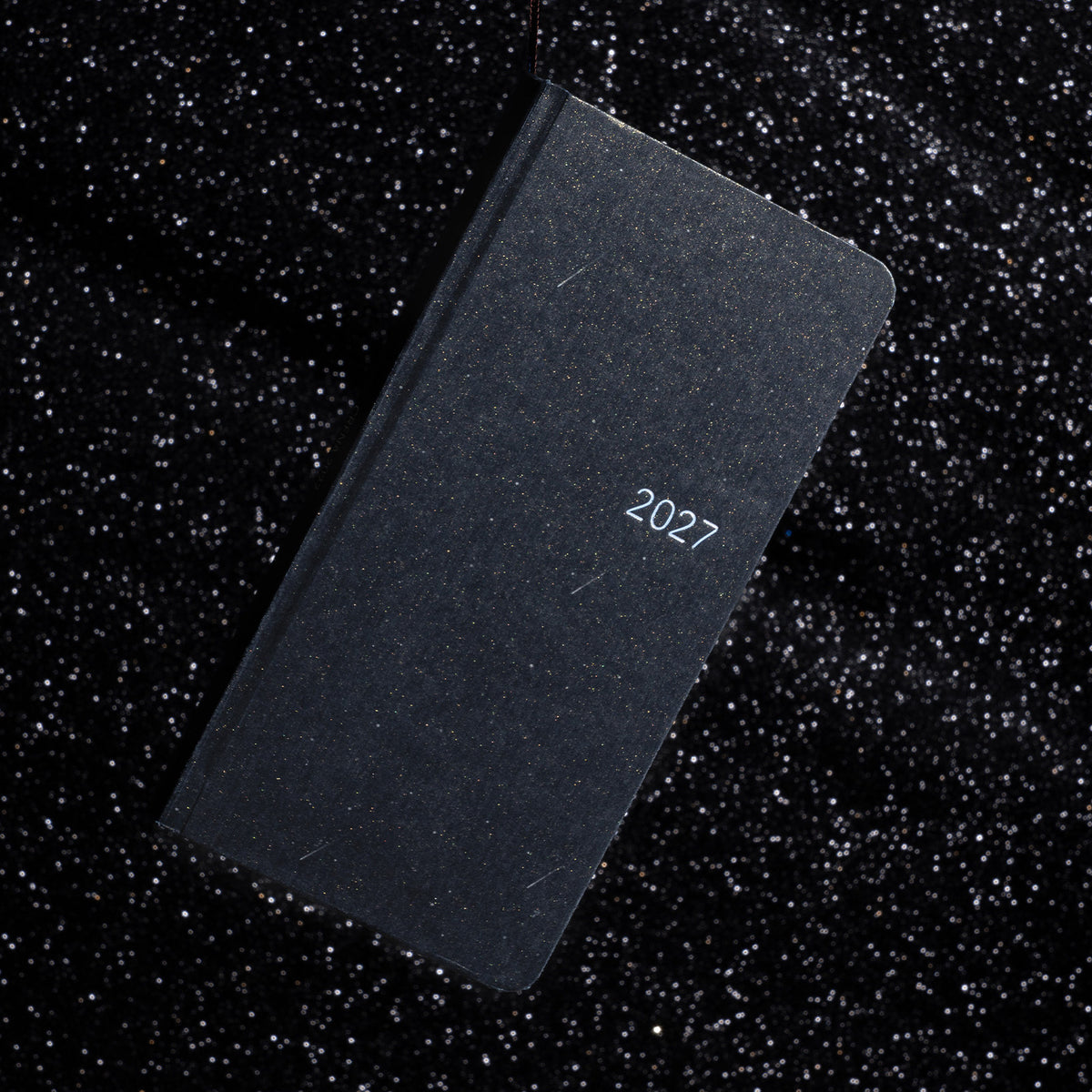 Black CRENA 2027 weekly planner with a textured cover and silver year lettering