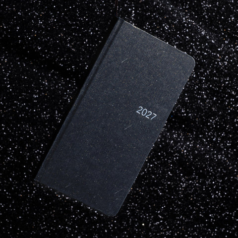 Black CRENA 2027 weekly planner with a textured cover and silver year lettering