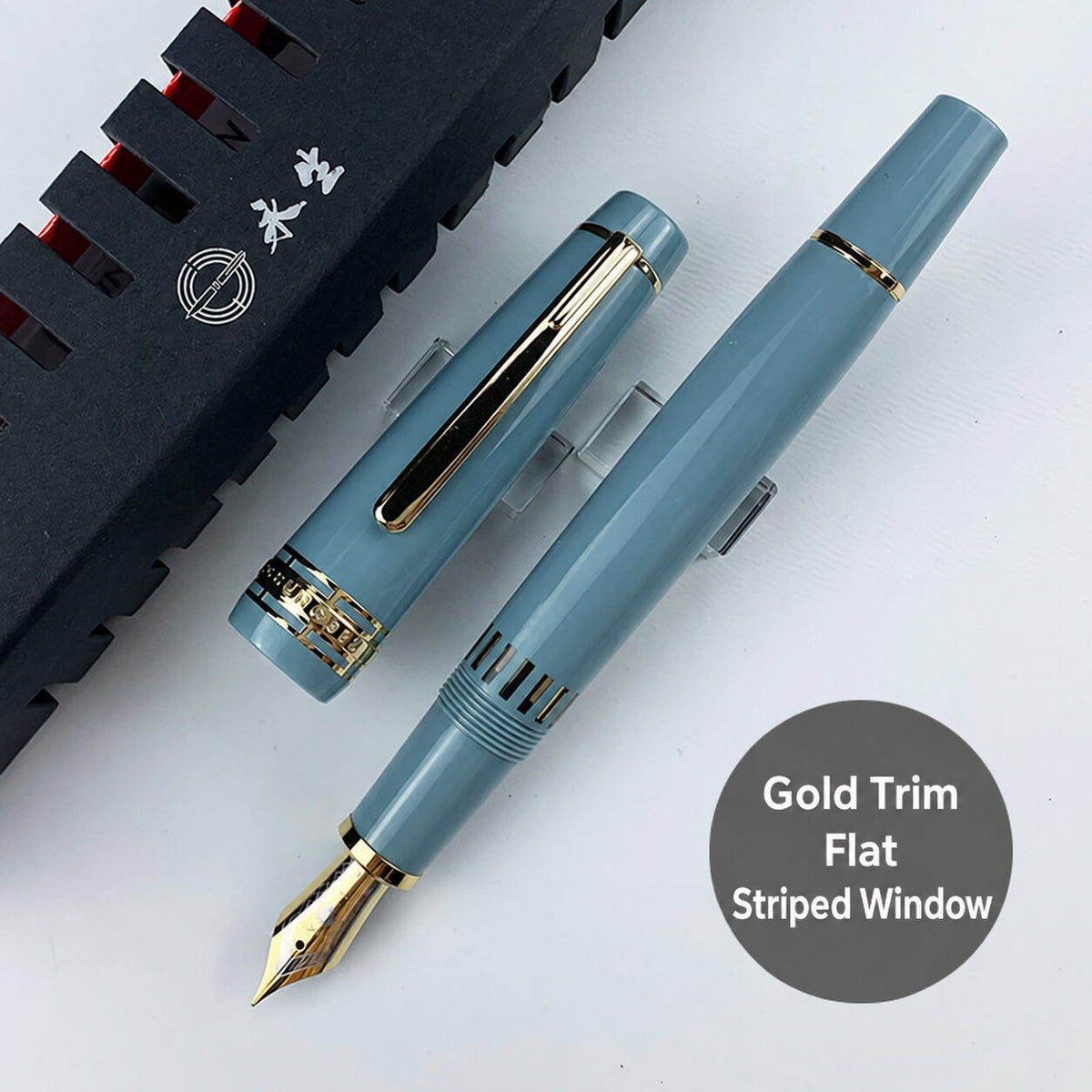 Lake-blue Wing Sung 629 fountain pen with gold-tone trim, flat ends, and a striped ink window